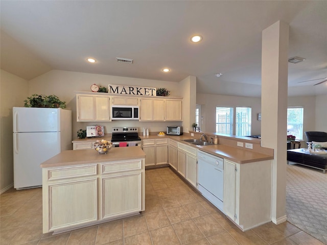 kitchen with vaulted ceiling, sink, ceiling fan, kitchen peninsula, and white appliances