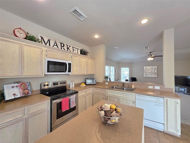 kitchen with sink, light tile patterned floors, ceiling fan, kitchen peninsula, and white appliances