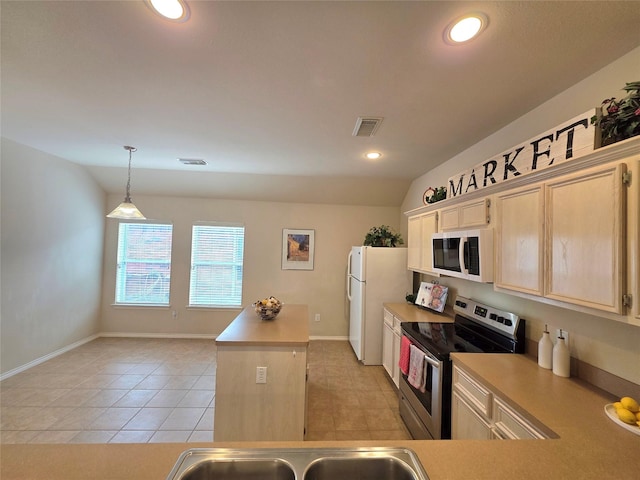 kitchen featuring lofted ceiling, light tile patterned floors, white appliances, a kitchen island, and decorative light fixtures