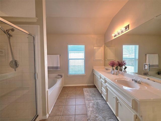 bathroom with tile patterned flooring, vaulted ceiling, vanity, and plus walk in shower