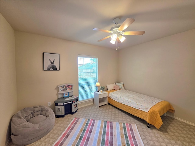 bedroom featuring ceiling fan and light carpet