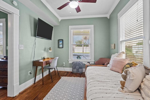 bedroom with hardwood / wood-style flooring, ceiling fan, and ornamental molding