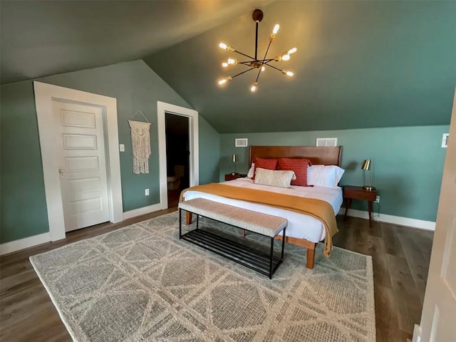 bedroom featuring hardwood / wood-style flooring, lofted ceiling, and a notable chandelier