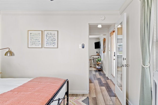 bedroom featuring crown molding and light hardwood / wood-style floors