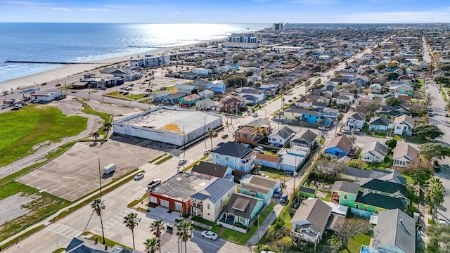 birds eye view of property with a water view and a beach view