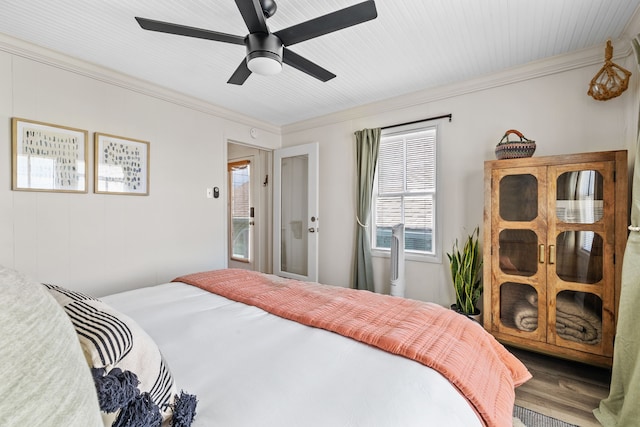 bedroom with crown molding, ceiling fan, and wood-type flooring