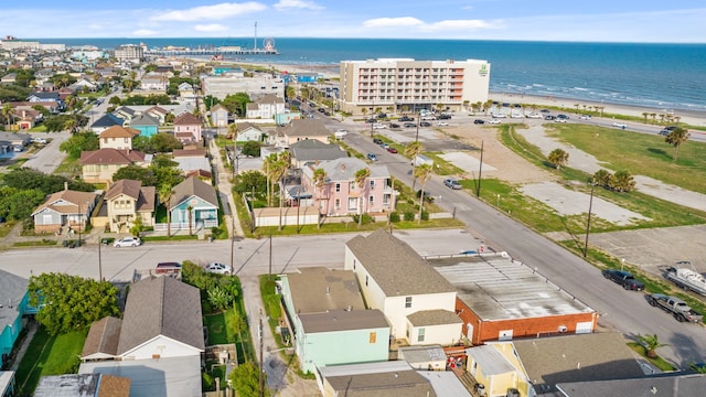 aerial view with a water view and a beach view