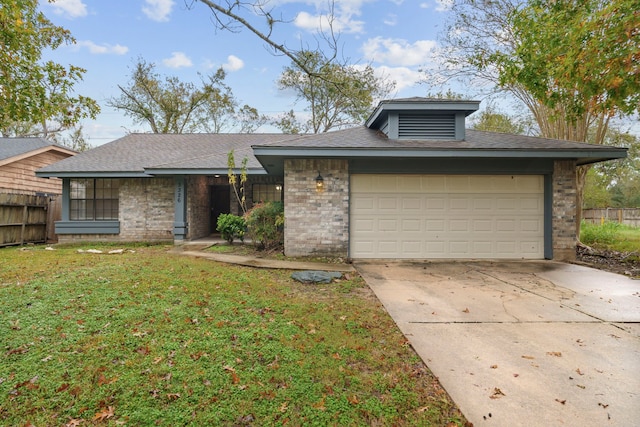 view of front of home featuring a garage and a front yard