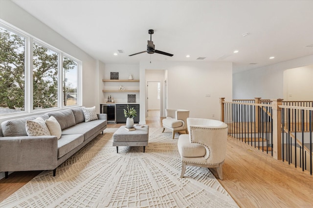 living area featuring visible vents, wine cooler, a dry bar, recessed lighting, and light wood-style floors