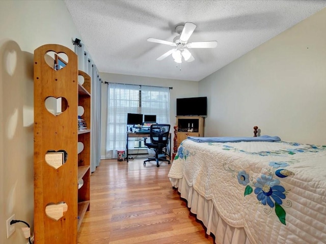 4 Rain Drop Dr, Lufkin, TX 75901 - bedroom featuring light wood finished floors, a textured ceiling, ceiling fan, and a desk