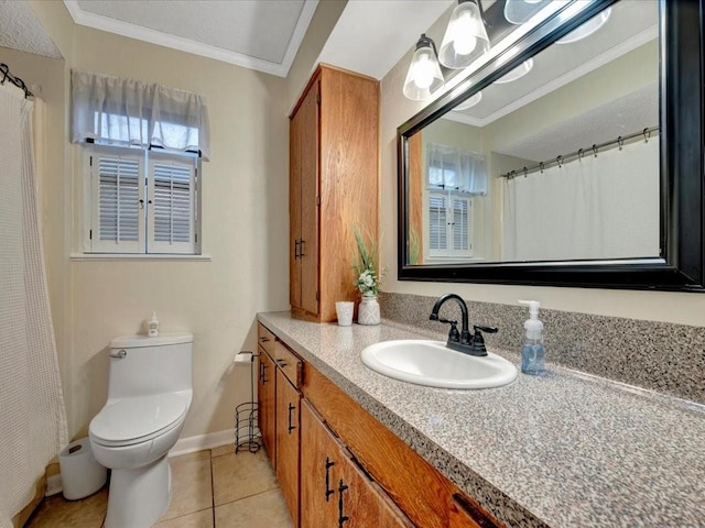 bathroom featuring tile patterned flooring, ornamental molding, vanity, and toilet