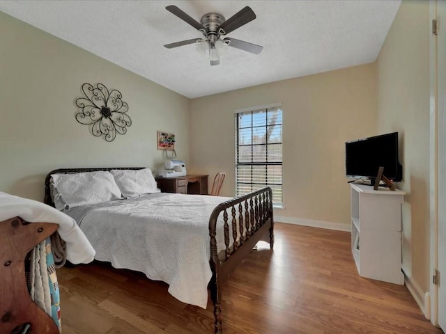 4 Rain Drop Dr, Lufkin, TX 75901 - bedroom with wood finished floors, baseboards, a textured ceiling, and a ceiling fan