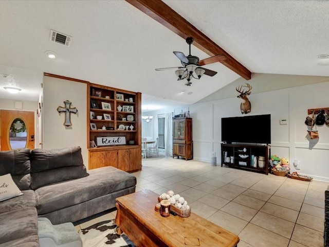 4 Rain Drop Dr, Lufkin, TX 75901 - living room featuring a decorative wall, light tile patterned floors, ceiling fan, a textured ceiling, and a chandelier