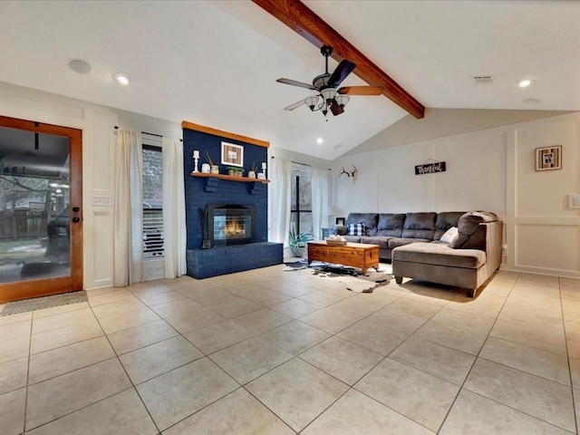 living room featuring lofted ceiling with beams, ceiling fan, light tile patterned floors, and a fireplace