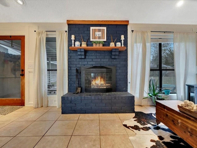 living room with light tile patterned floors and a fireplace