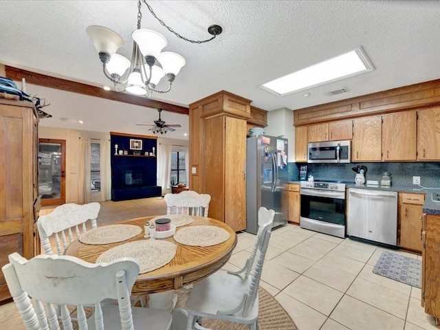 4 Rain Drop Dr, Lufkin, TX 75901 - dining room featuring a chandelier, light tile patterned floors, ceiling fan, and a textured ceiling