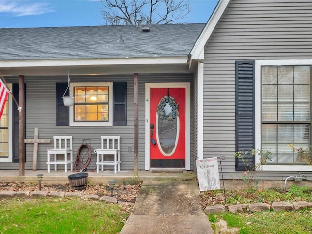 view of exterior entry featuring covered porch