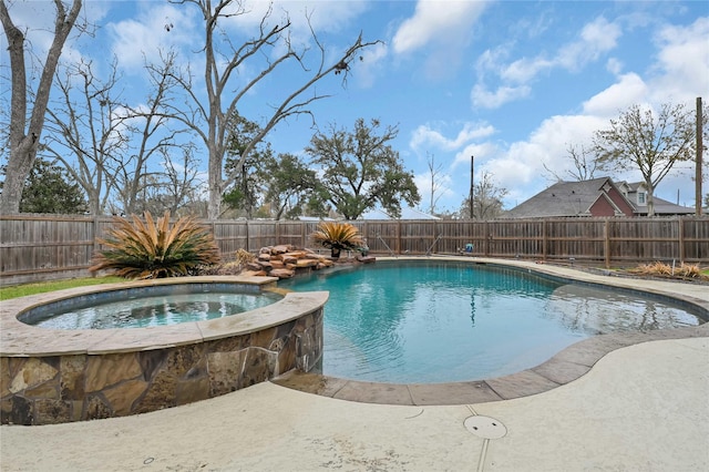 view of swimming pool featuring an in ground hot tub