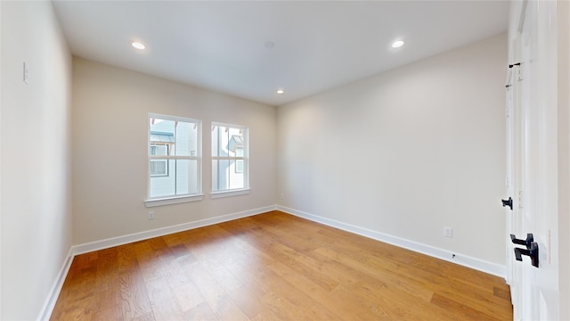 spare room with hardwood / wood-style flooring