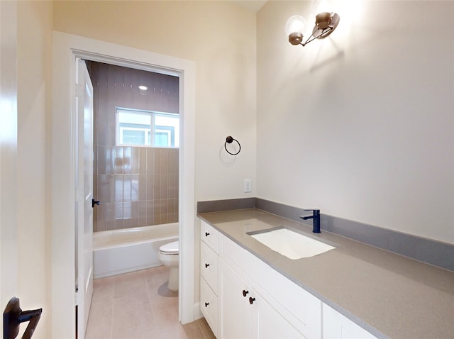 full bathroom with tile patterned flooring, vanity, tiled shower / bath combo, and toilet