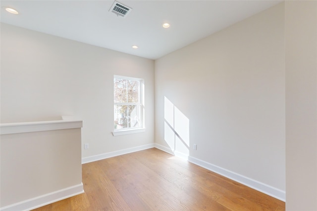 spare room with hardwood / wood-style floors