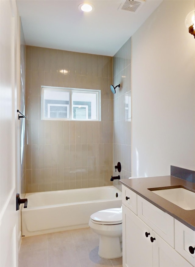 full bathroom featuring tiled shower / bath, tile patterned floors, toilet, and vanity