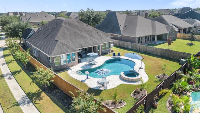 view of swimming pool with a lawn, a patio, and an in ground hot tub