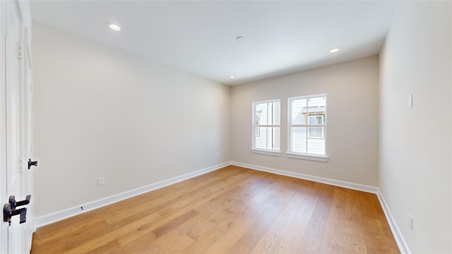 unfurnished room with light hardwood / wood-style floors