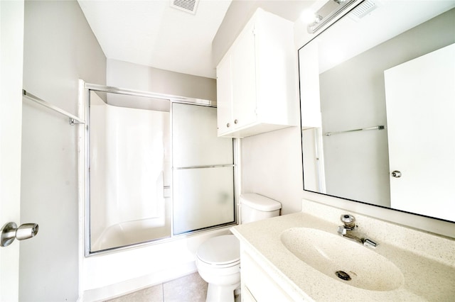 full bathroom with vanity, tile patterned flooring, enclosed tub / shower combo, and toilet