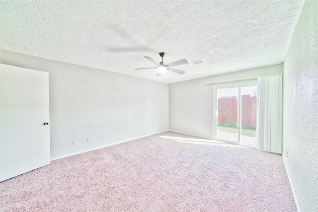 unfurnished room featuring ceiling fan, carpet flooring, and a textured ceiling