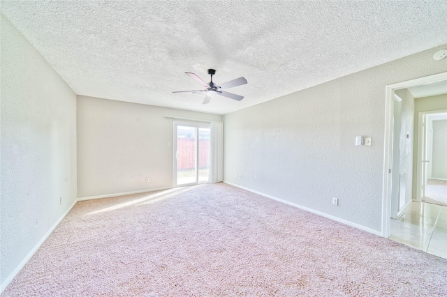 carpeted spare room with ceiling fan and a textured ceiling