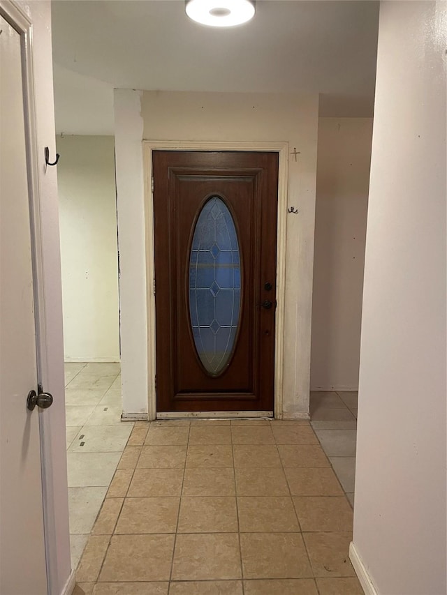 doorway to outside featuring light tile patterned floors