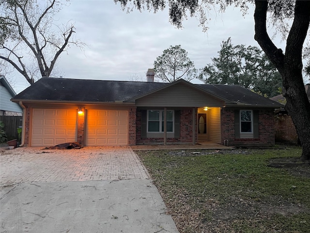 ranch-style home with a garage and a front yard