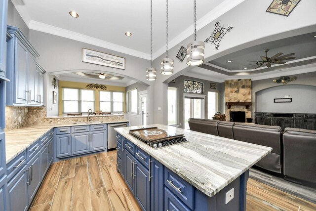 kitchen with pendant lighting, blue cabinetry, a center island, and appliances with stainless steel finishes