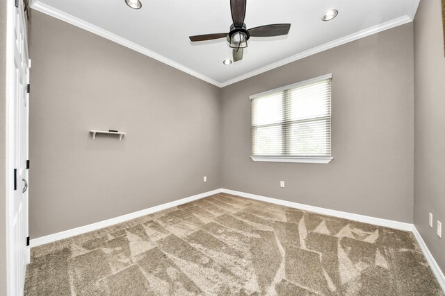 carpeted spare room with ornamental molding and ceiling fan