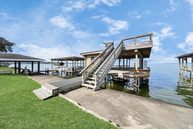 view of dock with a water view and a yard