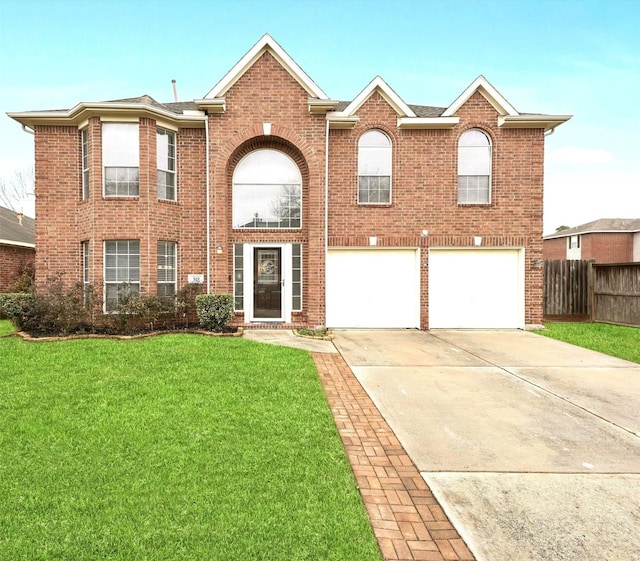 view of front of property featuring a garage and a front lawn