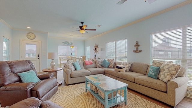 living room featuring light wood-type flooring, ceiling fan, and a wealth of natural light