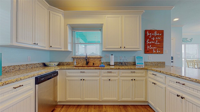 kitchen with sink, ornamental molding, dishwasher, kitchen peninsula, and light stone countertops