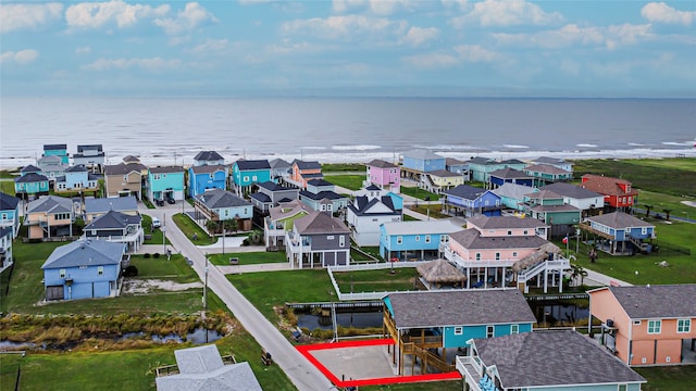 drone / aerial view featuring a water view and a residential view