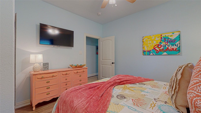 bedroom with ceiling fan and wood-type flooring