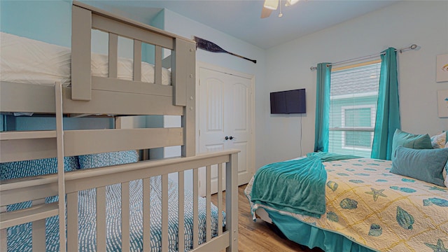 bedroom featuring a closet, wood finished floors, and a ceiling fan