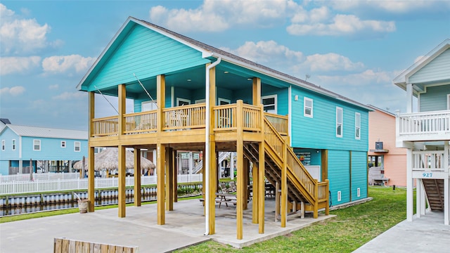 exterior space featuring a lawn, a patio, and a water view