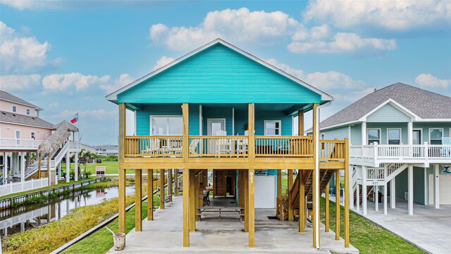 view of front of home with a water view, a carport, and covered porch