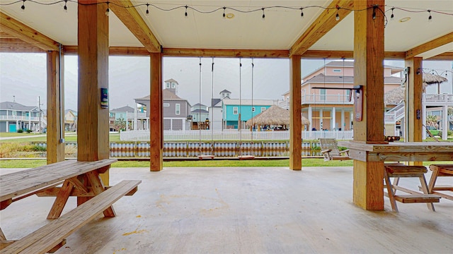 view of patio / terrace with a residential view and fence