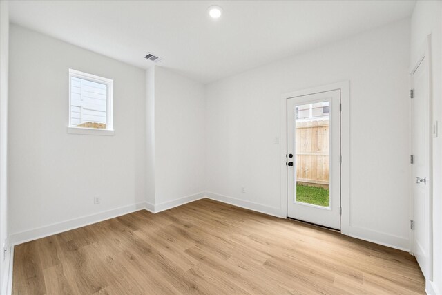 empty room with a healthy amount of sunlight and light wood-type flooring