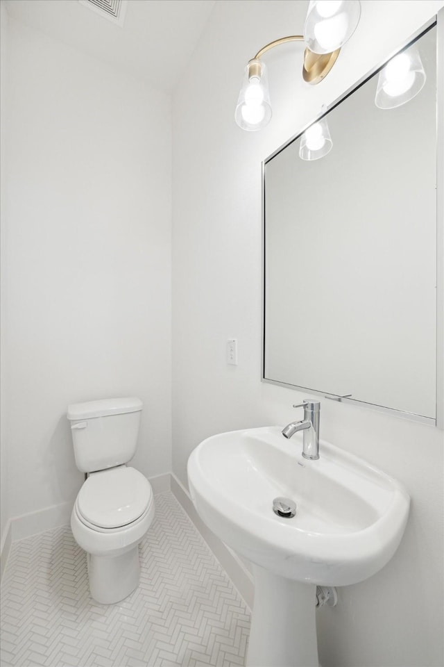 bathroom featuring tile patterned flooring, sink, and toilet