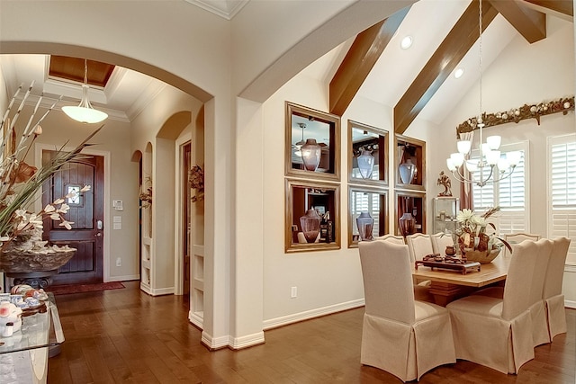 dining area featuring beam ceiling, ornamental molding, and dark hardwood / wood-style floors