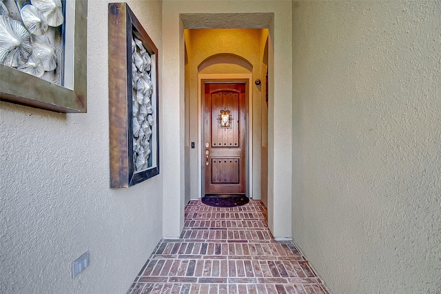 property entrance with stucco siding