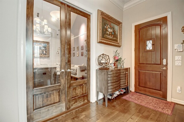 entryway featuring hardwood / wood-style flooring, ornamental molding, and french doors